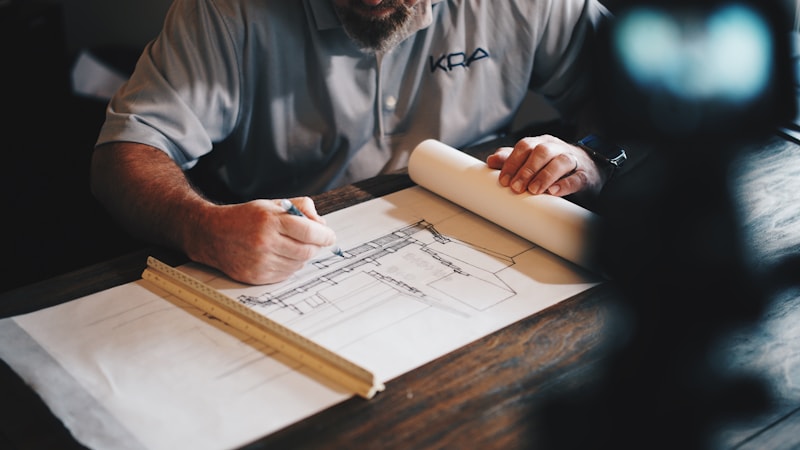 Architectural plans and construction documentation on table